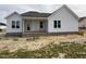 This home has white siding, a dark shingled roof, and an inviting front porch area at 71 Royal Ave, Selma, NC 27576