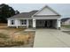 New construction home features a two-car garage, stone accents and light gray shutters at 71 Royal Ave, Selma, NC 27576