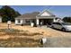 Charming one-story home featuring stone accents and a two-car garage and newly installed windows at 71 Royal Ave, Selma, NC 27576