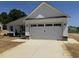 Charming home with a large two-car garage and bright white trim at 71 Royal Ave, Selma, NC 27576