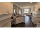 Modern kitchen with granite countertops, white cabinets, and stainless steel sink at 71 Royal Ave, Selma, NC 27576