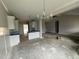 Open-concept kitchen features white cabinets, modern lighting, and connection to the living area at 71 Royal Ave, Selma, NC 27576