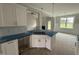 Kitchen island features a stainless sink, white cabinetry, and views of the fireplace at 71 Royal Ave, Selma, NC 27576