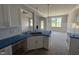 Modern kitchen with white cabinets and a large island, flowing into the living and dining spaces at 71 Royal Ave, Selma, NC 27576