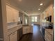 Modern kitchen features granite countertops, stainless steel appliances, and dark wood flooring at 71 Royal Ave, Selma, NC 27576