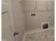 Utility room with patterned tile floors and white walls, ready for appliances at 71 Royal Ave, Selma, NC 27576