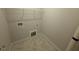 Functional laundry room with tile floors and ample space at 71 Royal Ave, Selma, NC 27576