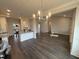 Open concept living room and kitchen featuring hardwood floors and modern lighting at 71 Royal Ave, Selma, NC 27576