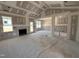 Unfinished living room showcasing a cozy fireplace, with large windows providing ample natural light at 71 Royal Ave, Selma, NC 27576