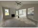 Bright living room featuring a fireplace, large windows, and an open concept layout at 71 Royal Ave, Selma, NC 27576
