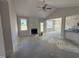 Open-concept living room features a fireplace, large windows, and an adjoining dining area, perfect for entertaining at 71 Royal Ave, Selma, NC 27576