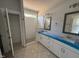 Main bathroom featuring double vanities, a tiled shower and a separate water closet at 71 Royal Ave, Selma, NC 27576