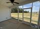 Screened in porch showing an expansive lawn with a ceiling fan at 71 Royal Ave, Selma, NC 27576