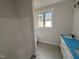 Bathroom featuring a walk-in shower, white vanity, and tile floors at 76 Royal Ave, Selma, NC 27576
