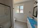 Bathroom featuring modern fixtures, glass enclosed shower, and tiled floor at 76 Royal Ave, Selma, NC 27576