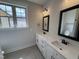 Bathroom featuring double sink vanity, quartz countertop and tiled floors at 76 Royal Ave, Selma, NC 27576