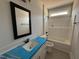 Bathroom featuring modern fixtures, tub and tiled floor at 76 Royal Ave, Selma, NC 27576