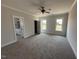 Primary bedroom featuring large windows, neutral walls and carpet at 76 Royal Ave, Selma, NC 27576
