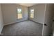 Empty bedroom featuring neutral walls, carpet and two windows at 76 Royal Ave, Selma, NC 27576