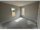 Bright bedroom featuring two windows providing natural light at 76 Royal Ave, Selma, NC 27576