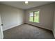 Empty bedroom with carpeted floors, one window, and white trim at 76 Royal Ave, Selma, NC 27576