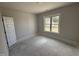 A simple, unfinished bedroom with a large window and bright natural light at 76 Royal Ave, Selma, NC 27576