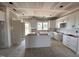 Modern kitchen with white cabinets, a center island, and a window above the sink at 76 Royal Ave, Selma, NC 27576