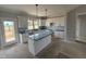 A kitchen with white cabinets, stainless steel appliances, an island, and pendant lighting at 76 Royal Ave, Selma, NC 27576