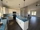 Open kitchen featuring white cabinets, modern appliances, and large island at 76 Royal Ave, Selma, NC 27576