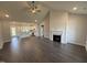 Spacious open-concept living area flows into the kitchen, with wood floors, high ceilings, and fireplace at 76 Royal Ave, Selma, NC 27576