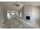 Bright living room with vaulted ceiling, modern ceiling fan, and fireplace with ship lap accent wall at 76 Royal Ave, Selma, NC 27576