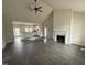 Open-concept living room featuring vaulted ceilings, fireplace, and hardwood floors at 76 Royal Ave, Selma, NC 27576