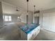 Open-concept living space featuring kitchen island, living room, and foyer with a vaulted ceiling at 76 Royal Ave, Selma, NC 27576