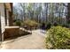 Back patio area with stairs, a wooden deck, and furniture overlooking the yard at 7605 Mine Valley Rd, Raleigh, NC 27615