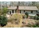 Aerial view of a private backyard with mature trees, landscaping, a patio, and a deck at 7605 Mine Valley Rd, Raleigh, NC 27615