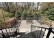 Deck with wooded scenery, metal furniture, and a nice railing at 7605 Mine Valley Rd, Raleigh, NC 27615