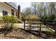 Backyard area with a patio, lush landscaping, and mature trees offering shade and privacy at 7605 Mine Valley Rd, Raleigh, NC 27615