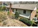 Rear exterior view of a single-Gathering home with siding and a brick chimney in a wooded backyard setting at 7605 Mine Valley Rd, Raleigh, NC 27615