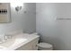 Bathroom with gray walls, marble countertop, new sink faucet, and matching blue accent tiles at 7605 Mine Valley Rd, Raleigh, NC 27615