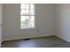 Bedroom with ample natural light, durable gray floors, and neutral paint at 7605 Mine Valley Rd, Raleigh, NC 27615