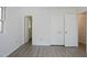 Bedroom with gray floors, neutral paint, and spacious double door closet at 7605 Mine Valley Rd, Raleigh, NC 27615
