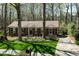 Charming brick home with a well-maintained lawn and mature trees creating a serene and inviting atmosphere at 7605 Mine Valley Rd, Raleigh, NC 27615