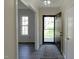 Inviting foyer with a dark front door, neutral walls, and hardwood flooring at 7605 Mine Valley Rd, Raleigh, NC 27615