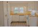 Bright kitchen featuring white appliances, wooden countertops, and a window providing natural light at 7605 Mine Valley Rd, Raleigh, NC 27615