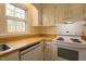 Kitchen with white cabinets, wooden countertops, and an electric range stove at 7605 Mine Valley Rd, Raleigh, NC 27615