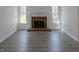 Spacious living room with hardwood floors, a brick fireplace, and large windows at 7605 Mine Valley Rd, Raleigh, NC 27615