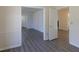 Living room showing neutral paint, gray flooring, white trim, and multiple doorways at 7605 Mine Valley Rd, Raleigh, NC 27615