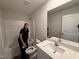Clean bathroom with a tub and shower combo, vanity with sink, and neutral-toned walls at 8 W Emily Gardens Dr, Selma, NC 27576