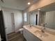 Modern bathroom with double vanity, quartz countertops, and a large mirror, perfect for daily routines at 8 W Emily Gardens Dr, Selma, NC 27576