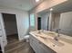 Bright bathroom with double vanity sinks, white cabinets and tile flooring at 8 W Emily Gardens Dr, Selma, NC 27576